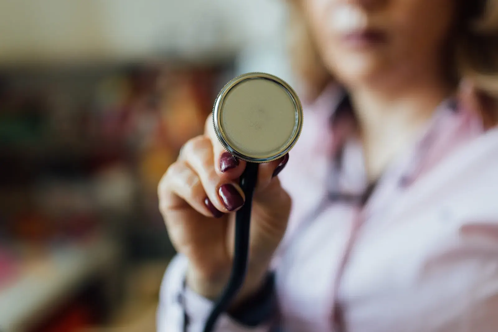A stethoscope held in the hand, close up.